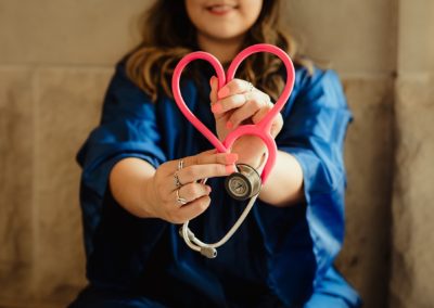 Woman holding stethoscope on heart shape